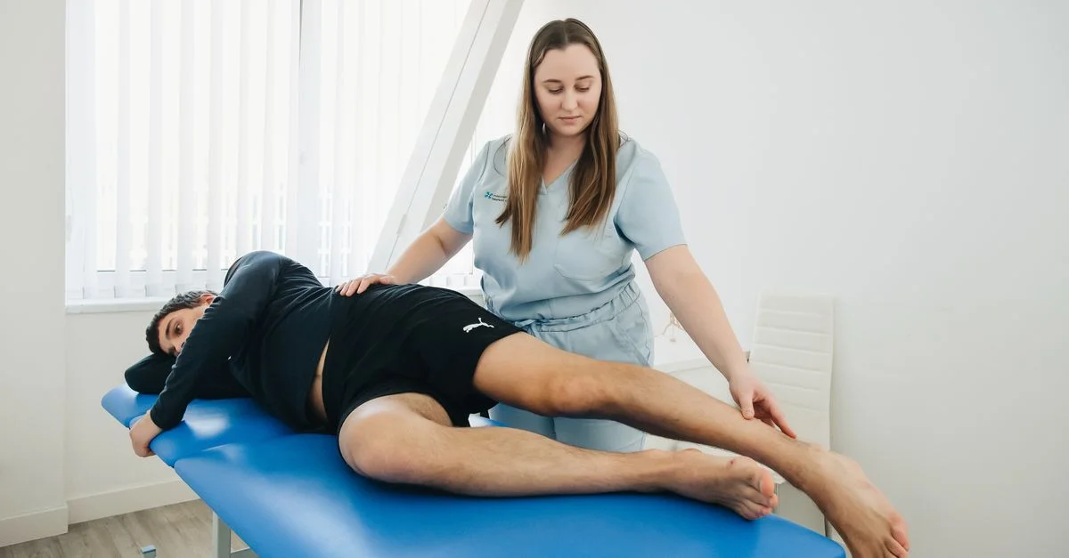 Un physiothérapeute aide un patient lors d'une séance de réhabilitation dans une clinique à Vilnius.
